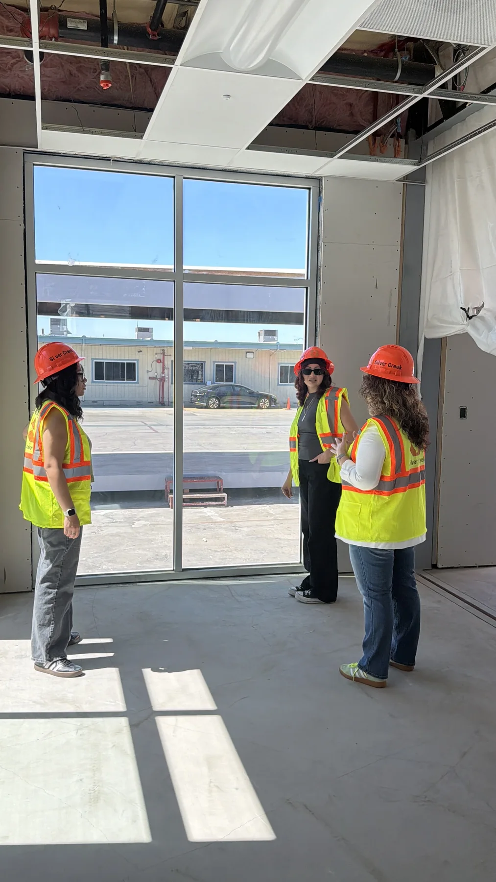 Lupe Gomez touring a local construction project with community partners