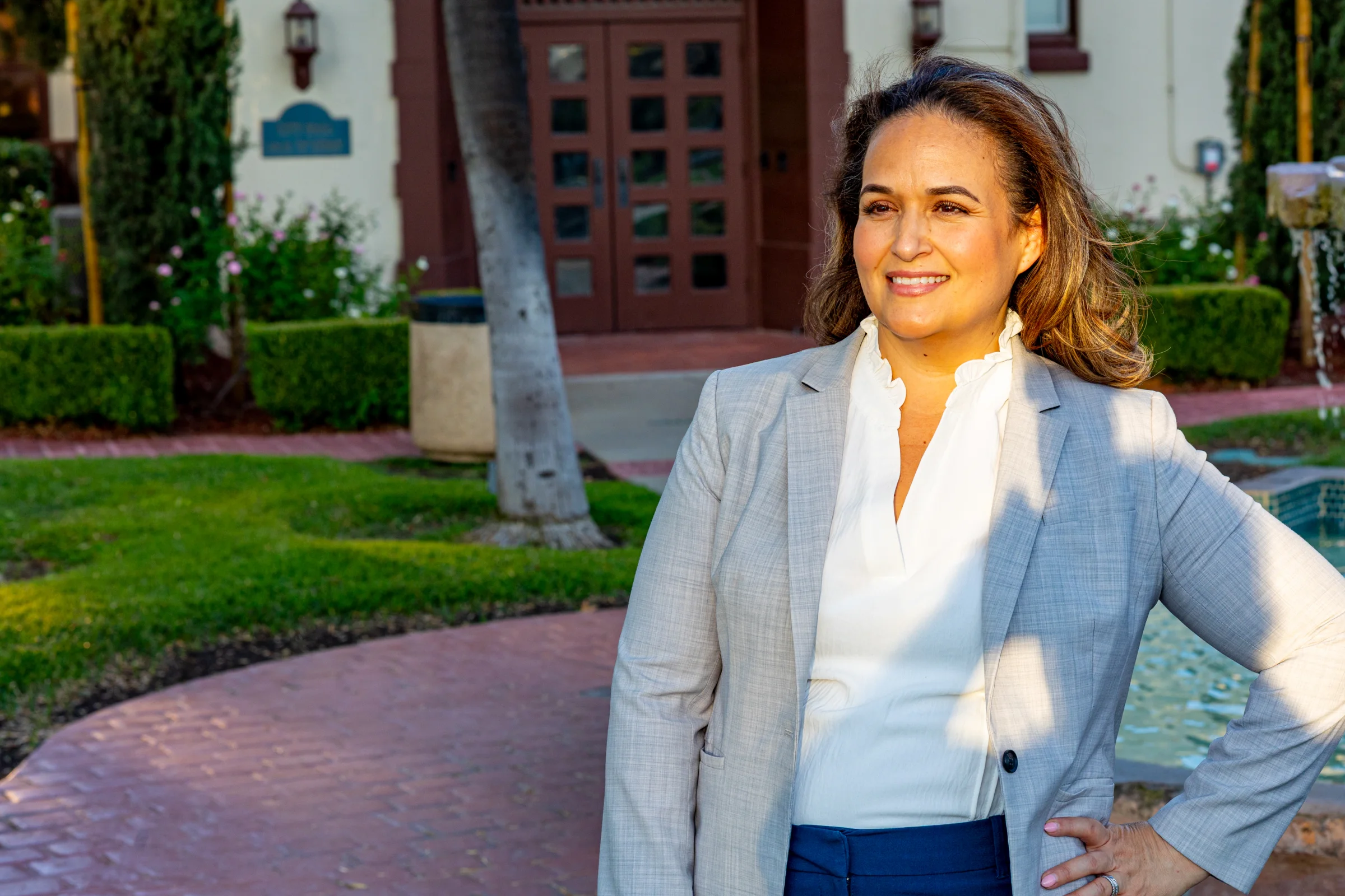 Lupe Gomez standing confidently outside a Perris civic building