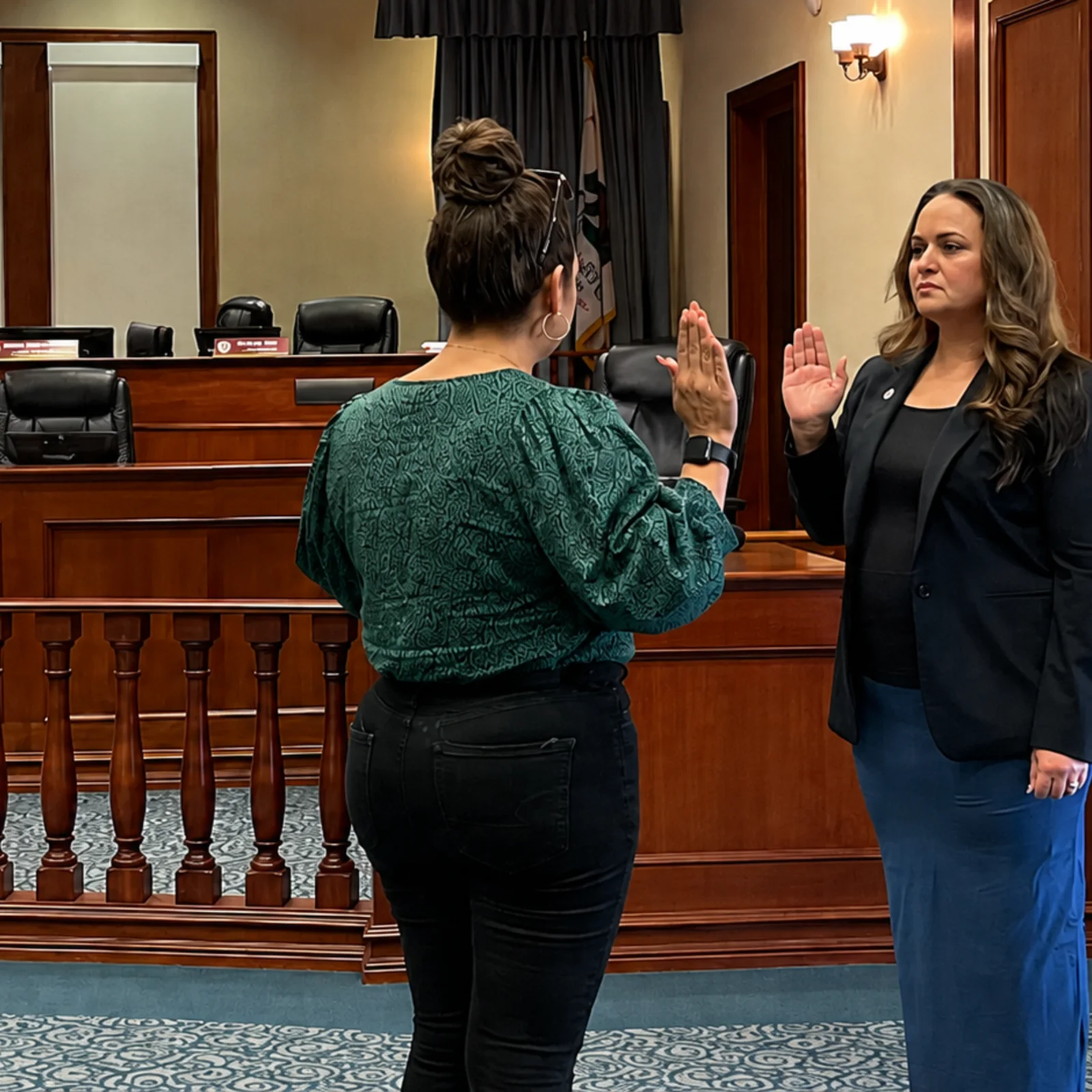 Lupe Gomez taking the oath of office in the council chamber