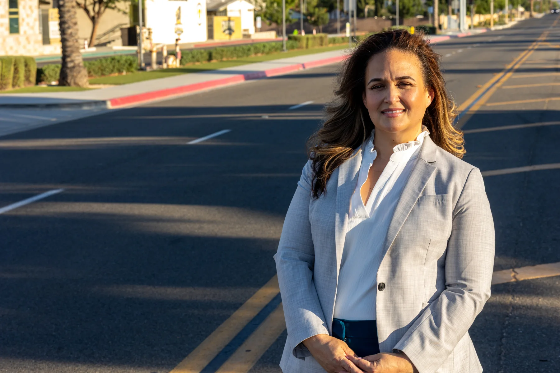 Lupe Gomez standing on a neighborhood street in Perris